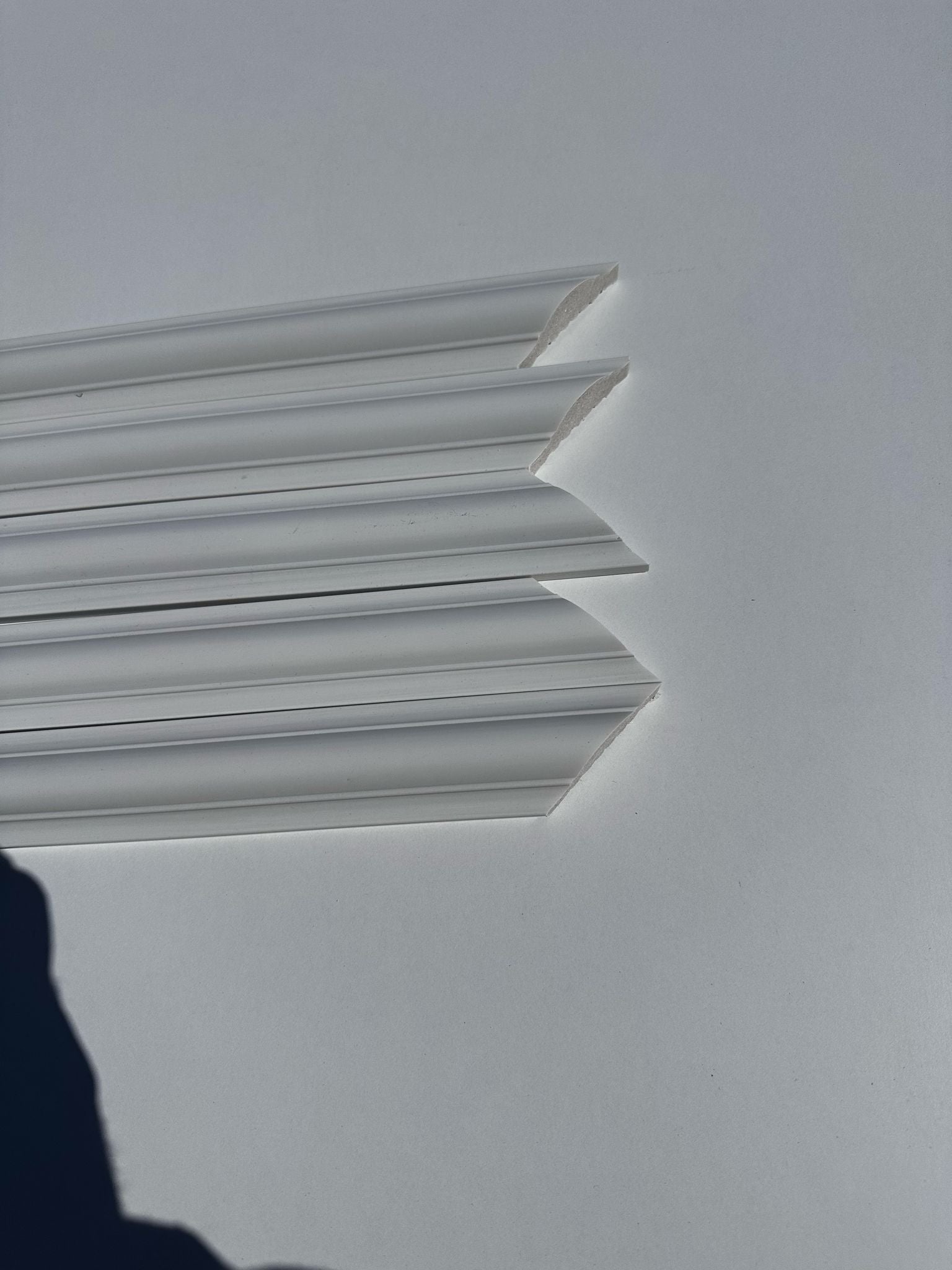 Close-up of wall molding pieces showing paintable surface