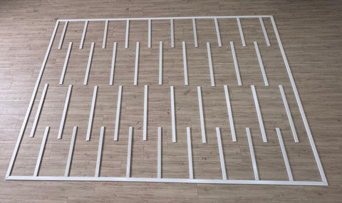 Primed wall paneling kit with clean rectangular frame layout