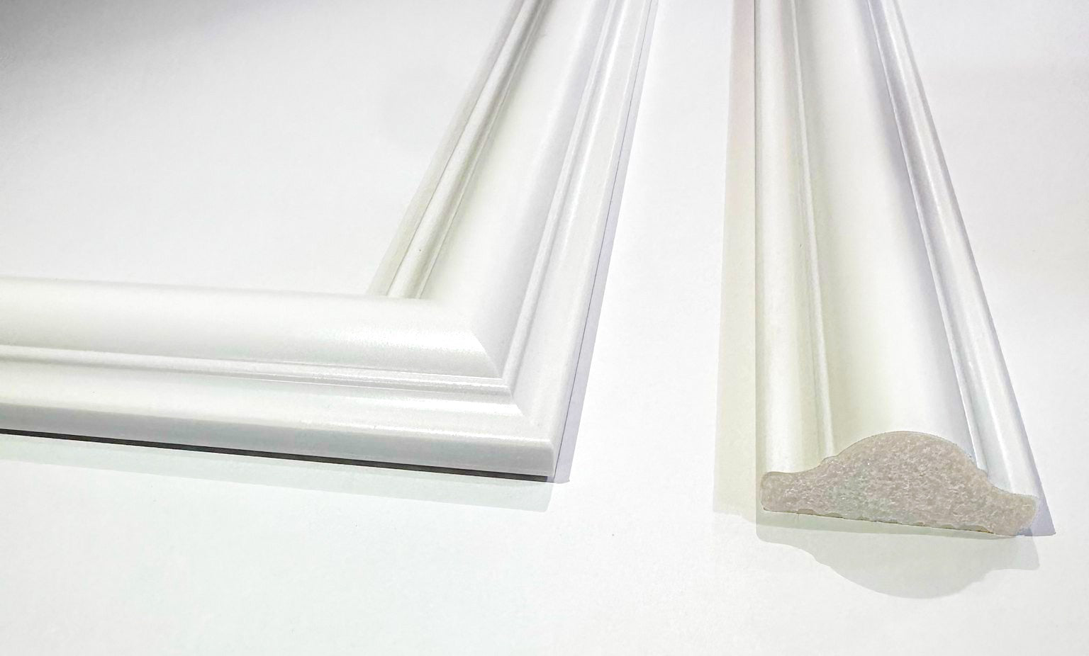 Close-up of wall molding frames showing clean edges and paintable surface